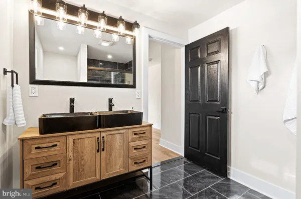 a bathroom with a double vanity sink and mirror