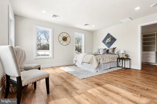 a bed room with a bed and a chair