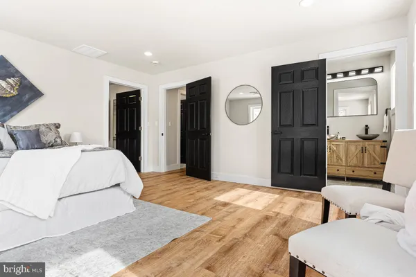 a bedroom with a bed and a chair