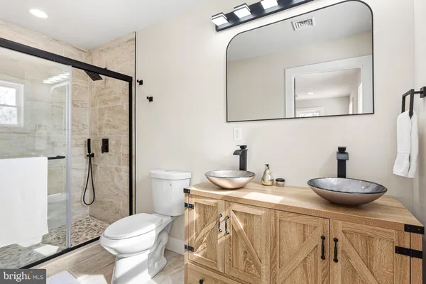 a bathroom with a sink toilet and shower
