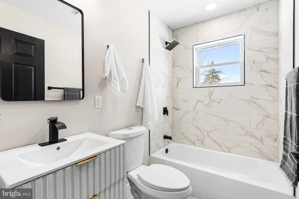 a bathroom with a toilet sink and bathtub