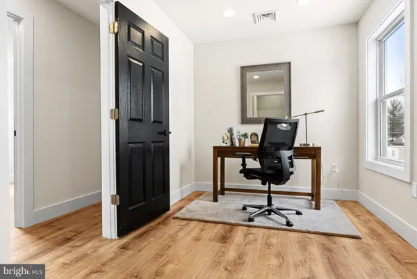 a room with gym equipment and windows