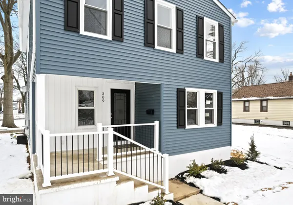 a view of a brick house with wooden fence