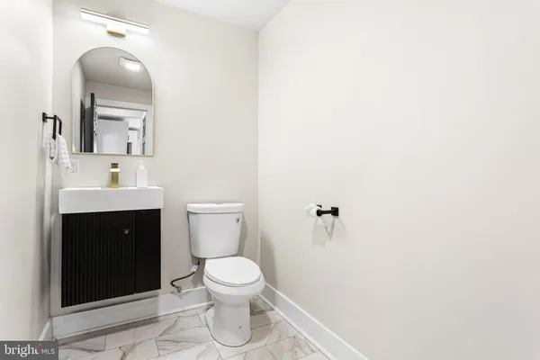 a white toilet sitting next to a bathroom sink