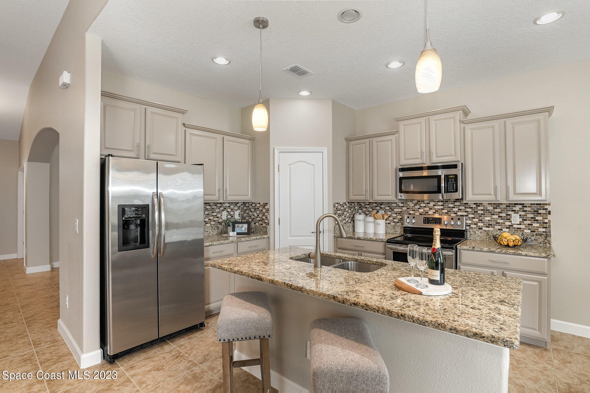 3545 Sansome Circle Melbourne, FL 32940 - Photo 11 of 27 a kitchen with stainless steel appliances granite countertop a sink refrigerator and microwave