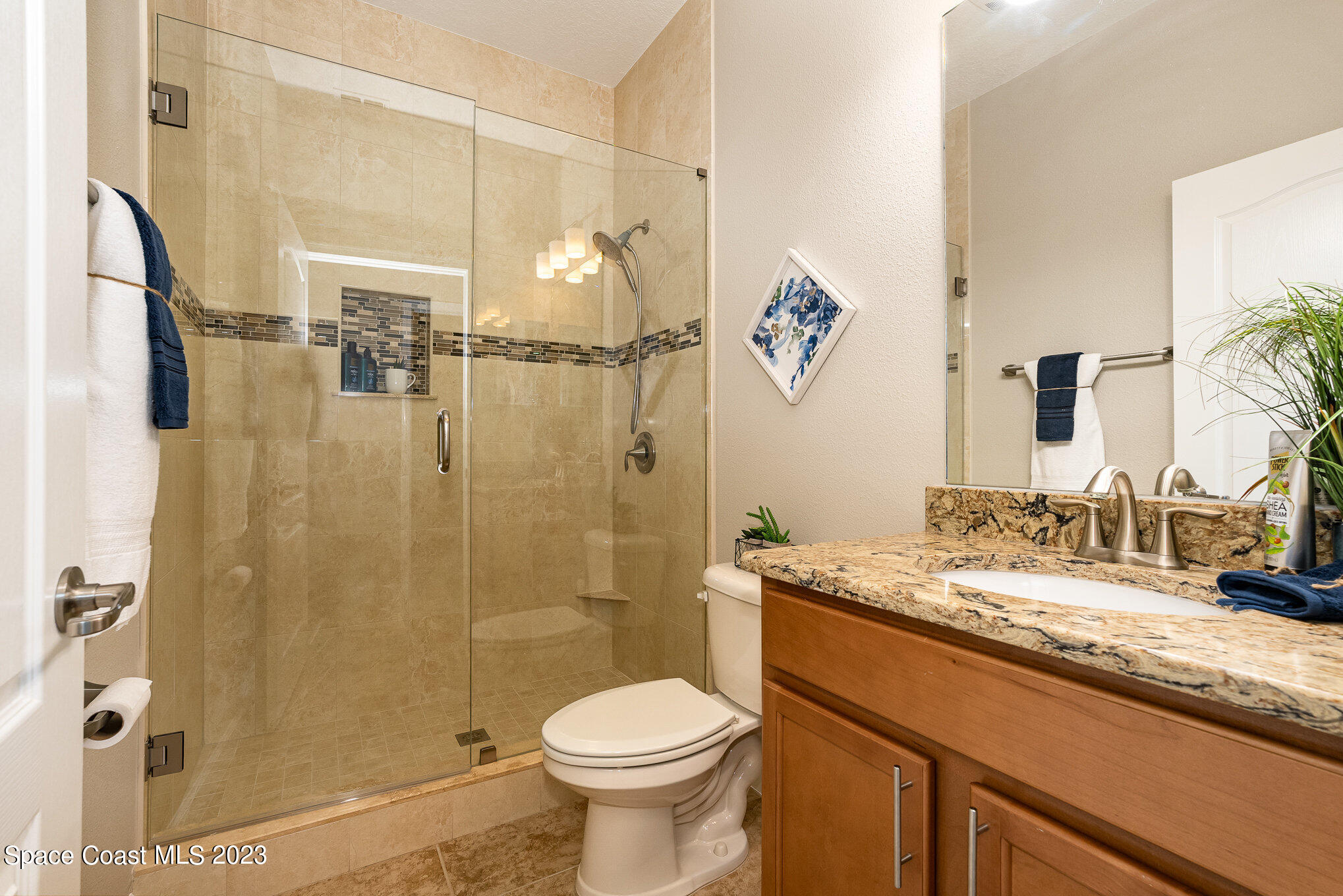3545 Sansome Circle Melbourne, FL 32940 - Photo 20 of 27 a bathroom with a granite countertop sink toilet and shower