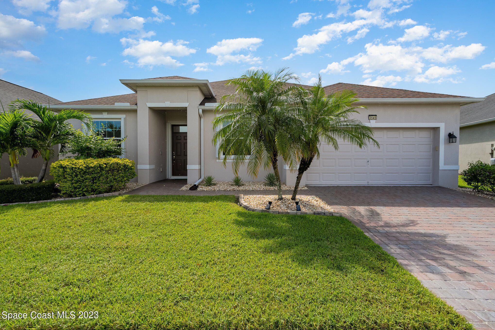 3545 Sansome Circle Melbourne, FL 32940 - Photo 2 of 27 a view of a house with a yard and palm tree
