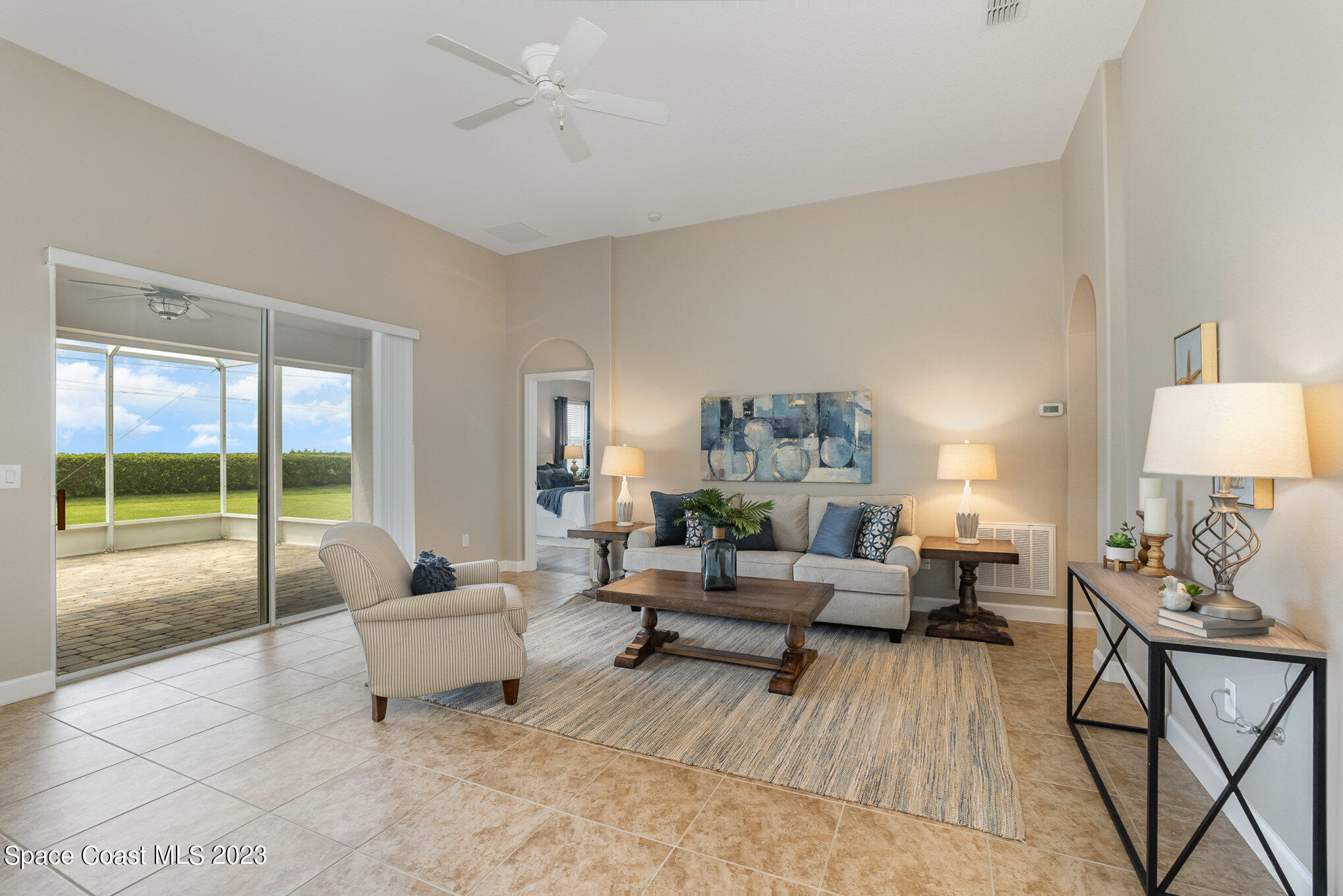 3545 Sansome Circle Melbourne, FL 32940 - Photo 5 of 27 a living room with furniture and a large window with balcony view