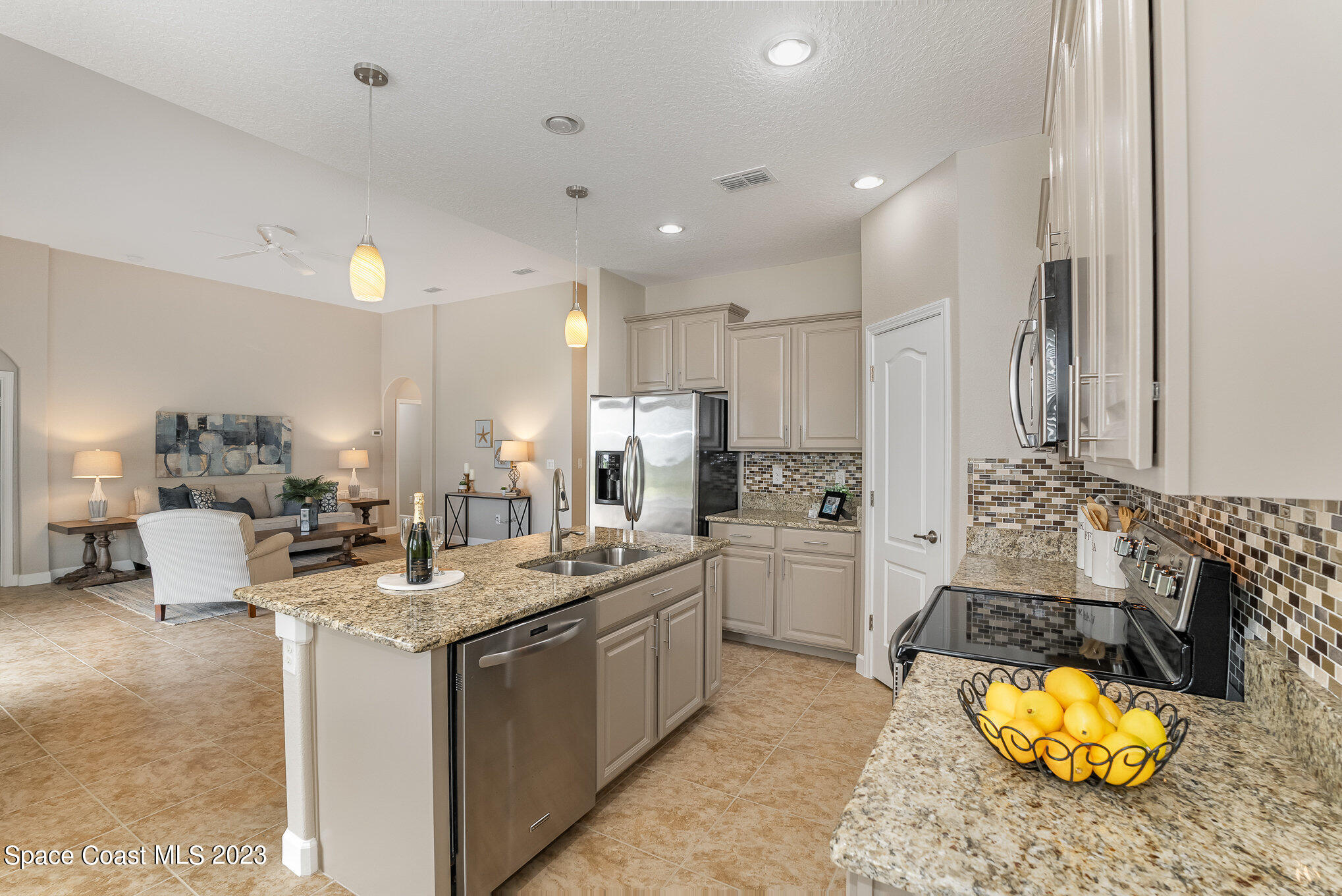 3545 Sansome Circle Melbourne, FL 32940 - Photo 10 of 27 a kitchen with sink stove and living room