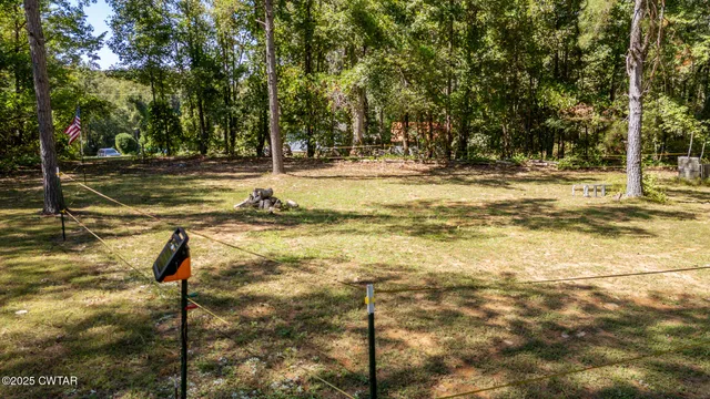 a view of swimming pool with outdoor seating and trees