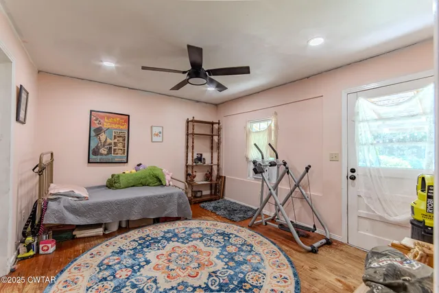 a view of a livingroom with furniture and gym equipment