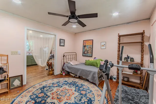 a bedroom with furniture and a wooden floor