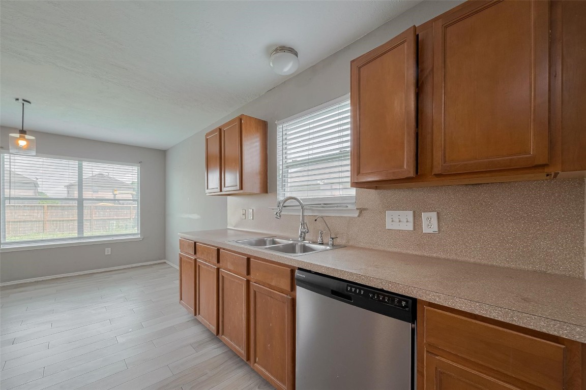 9926 Myrtle Field Lane Houston, TX 77044 - Photo 12 of 33 a kitchen with a sink cabinets and window