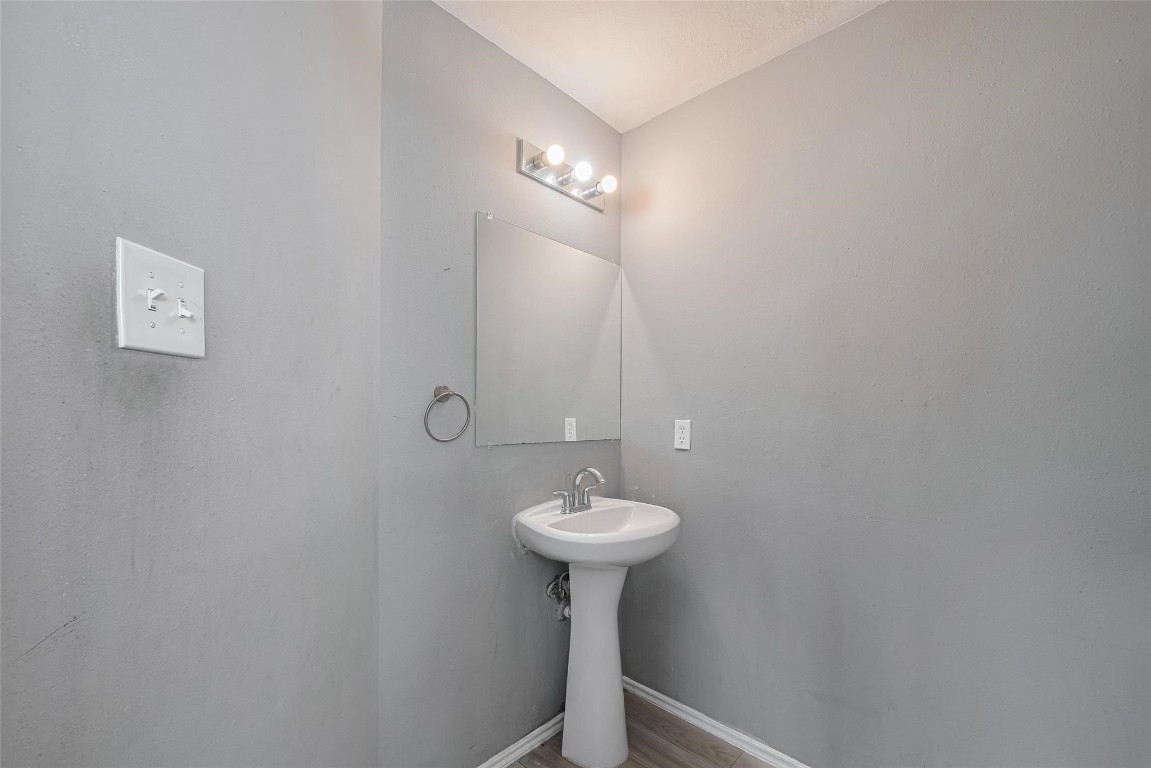 9926 Myrtle Field Lane Houston, TX 77044 - Photo 16 of 33 a bathroom with a sink a light fixture and a light fixture