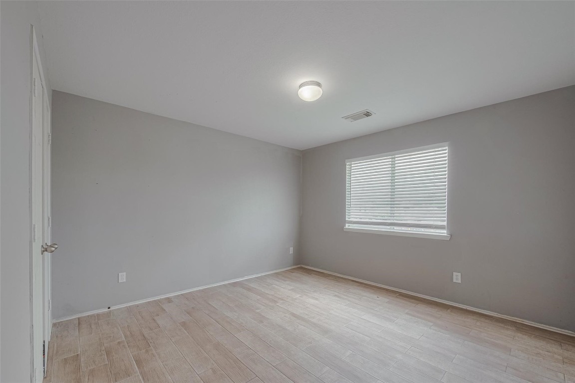9926 Myrtle Field Lane Houston, TX 77044 - Photo 17 of 33 an empty room with a window