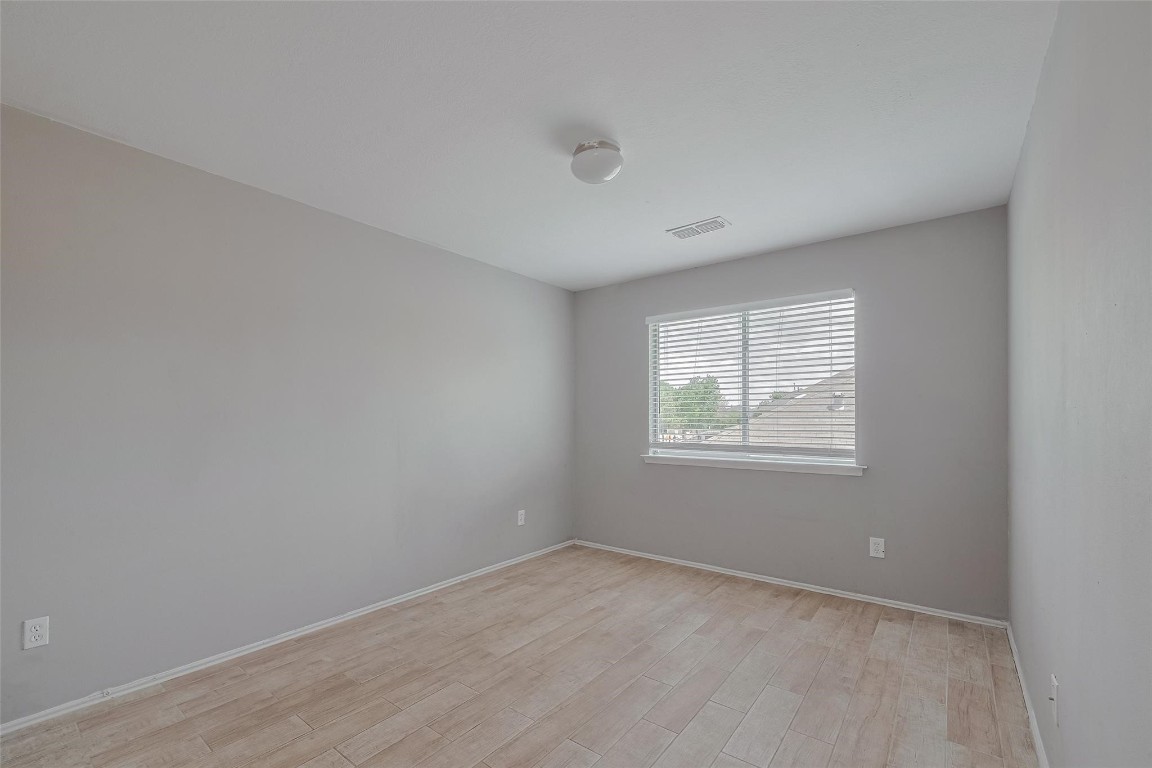 9926 Myrtle Field Lane Houston, TX 77044 - Photo 19 of 33 an empty room with windows