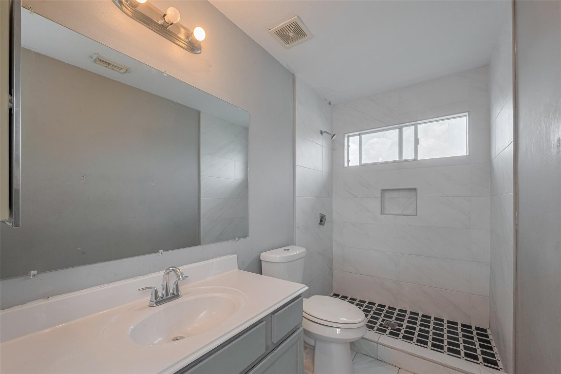 9926 Myrtle Field Lane Houston, TX 77044 - Photo 23 of 33 a bathroom with a sink a toilet and shower