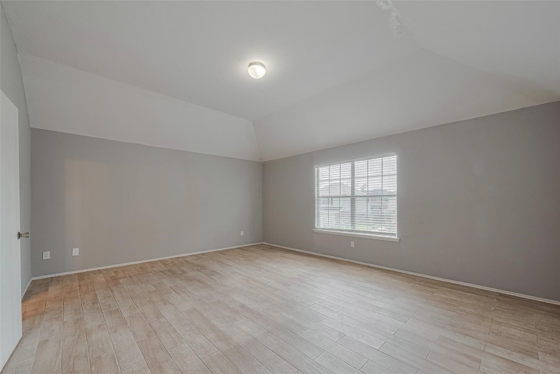 9926 Myrtle Field Lane Houston, TX 77044 - Photo 24 of 33 wooden floor in an empty room with a window