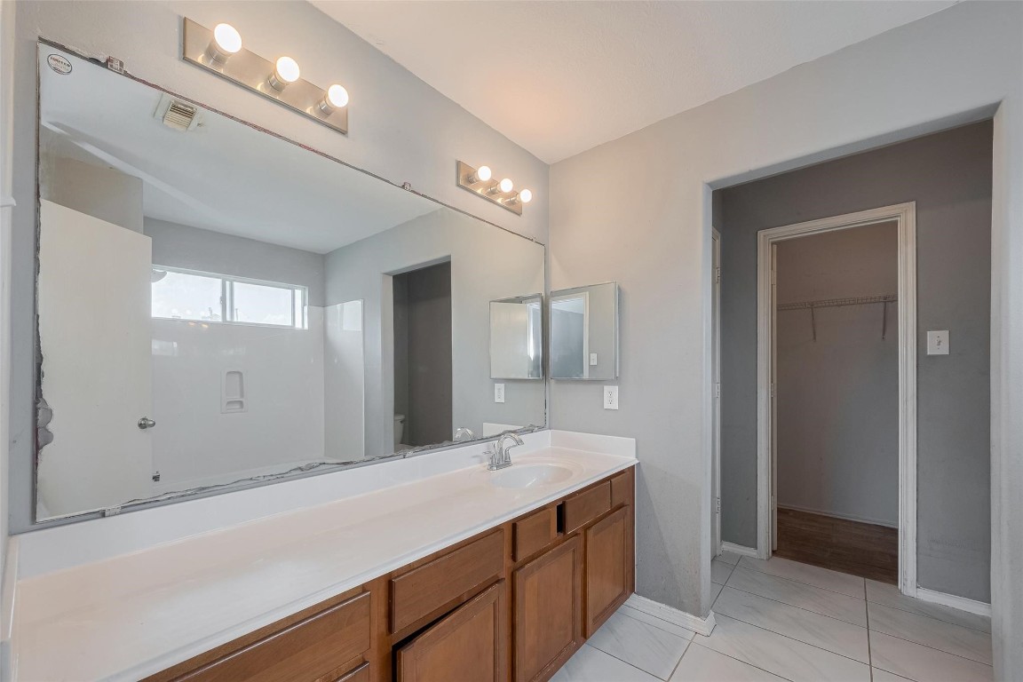 9926 Myrtle Field Lane Houston, TX 77044 - Photo 27 of 33 a bathroom with a sink and a mirror