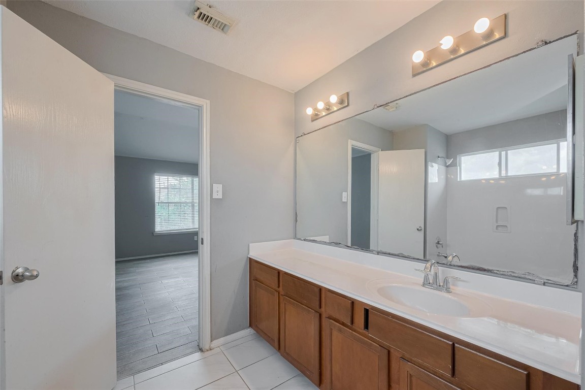 9926 Myrtle Field Lane Houston, TX 77044 - Photo 28 of 33 a bathroom with a sink and a mirror
