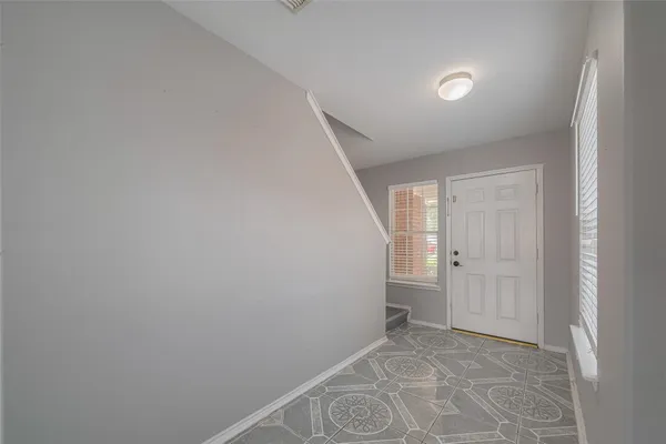 a view of an empty room and a window
