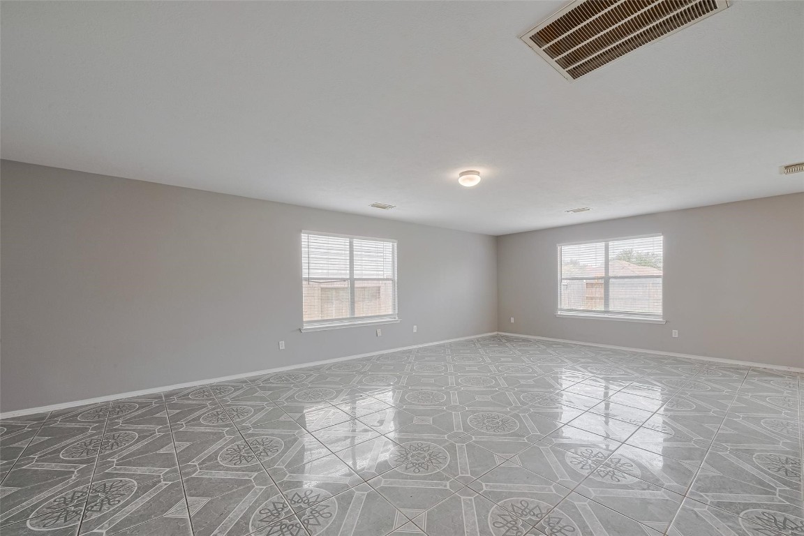 9926 Myrtle Field Lane Houston, TX 77044 - Photo 5 of 33 an empty room with windows