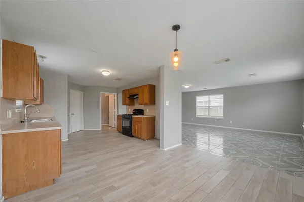 a kitchen with granite countertop a stove top oven and sink