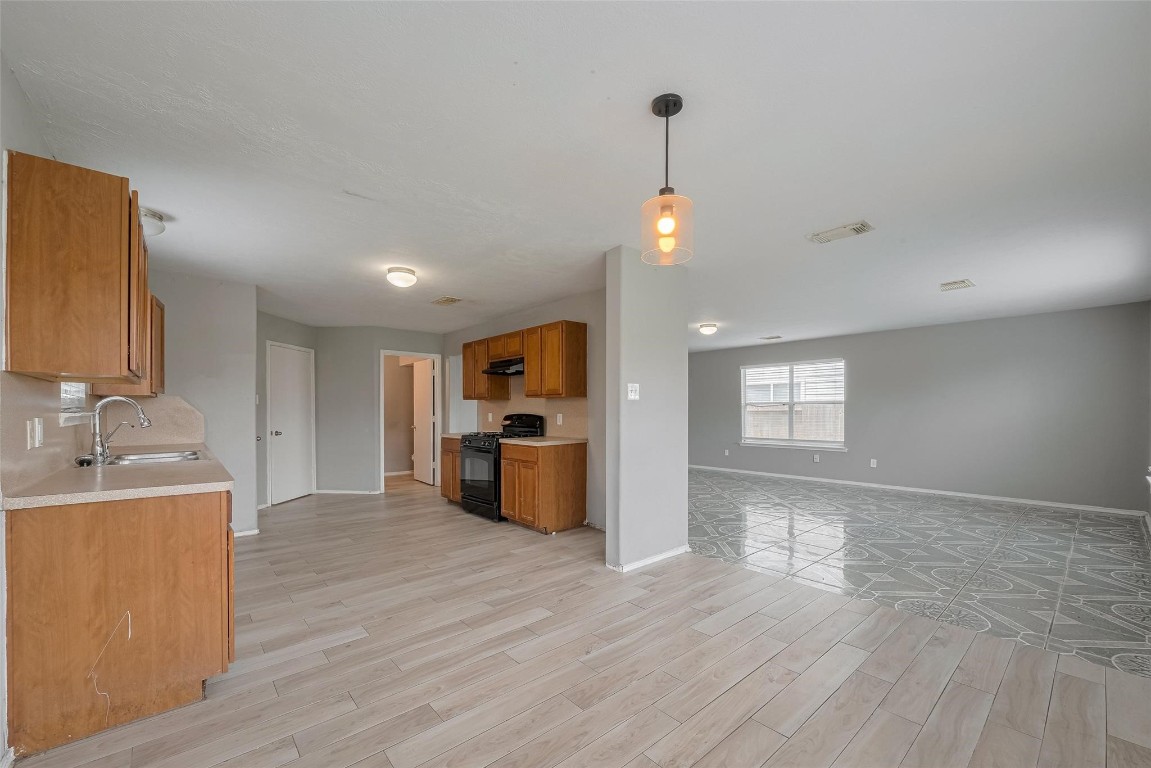9926 Myrtle Field Lane Houston, TX 77044 - Photo 7 of 33 a view of a kitchen with a sink and a window