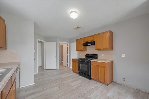 a view of a kitchen with a sink dishwasher refrigerator and window