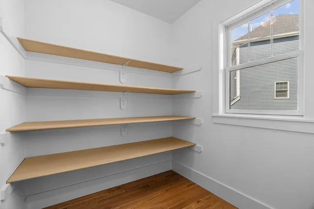 a view of room with wooden floor and a window