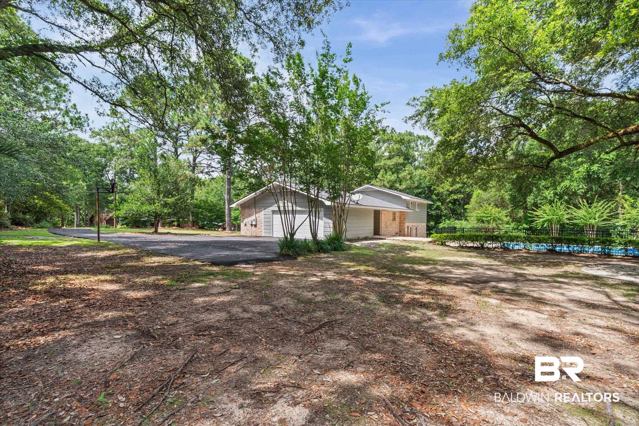 8301 Fordham Road Mobile, AL 36619 - Photo 35 of 57 Expansive lot featuring mature trees, a multi-car driveway, and a detached two-car garage