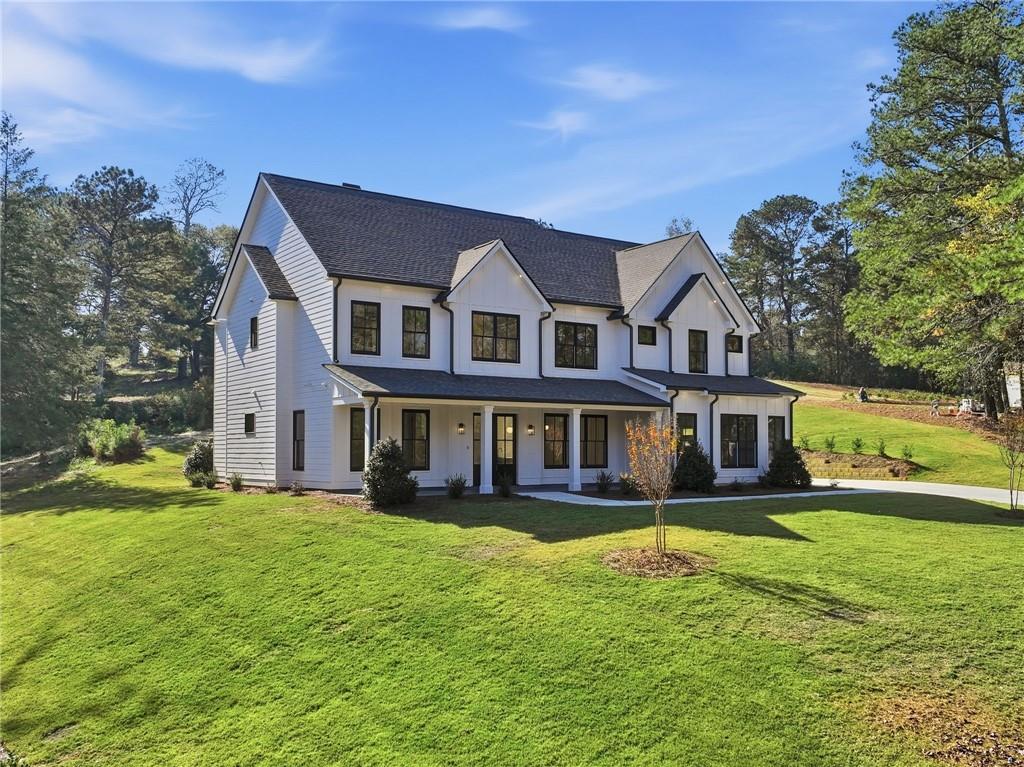 a house that has a big yard with plants and trees in it