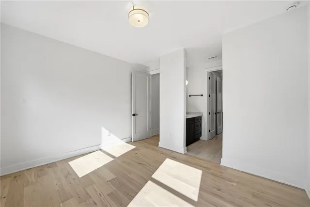a view of a hallway with wooden floor and windows
