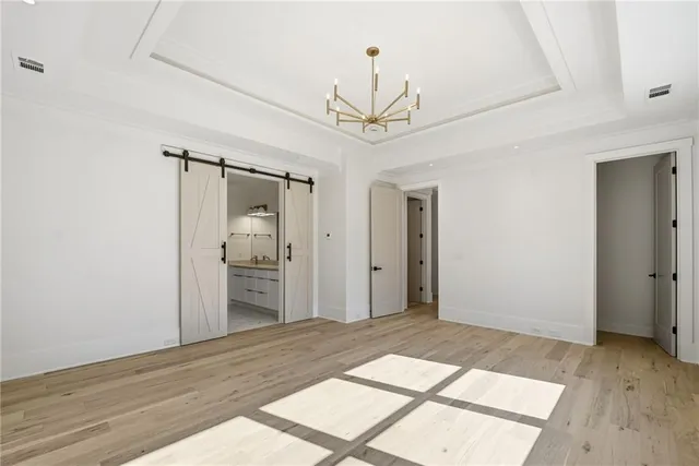 a spacious bathroom with a granite countertop sink a toilet and a mirror