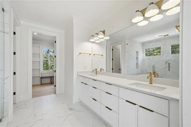 a spacious bathroom with a shower sink and mirror