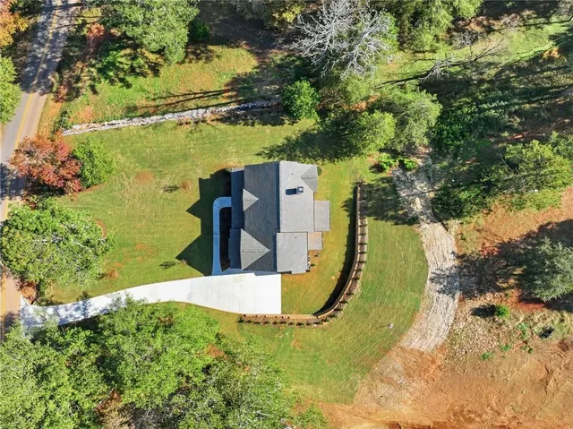an aerial view of a house with a yard