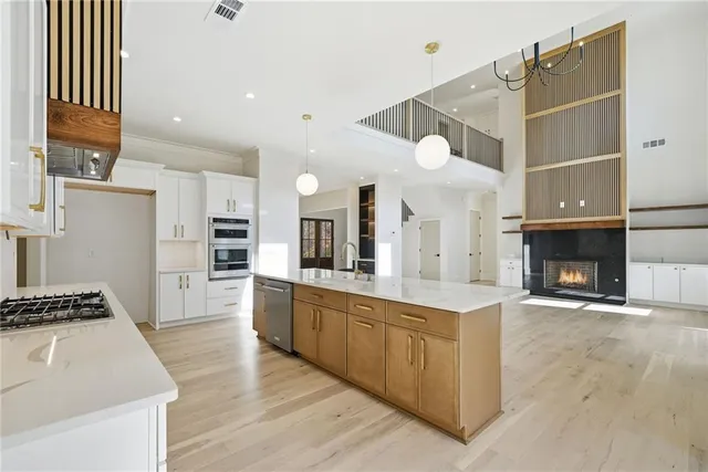 a kitchen with stainless steel appliances kitchen island wooden cabinets and stove