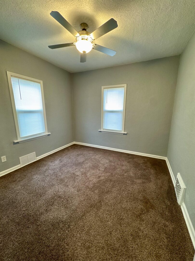 4227 11th Street Rock Island, IL 61201 - Photo 5 of 12 an empty room with a window