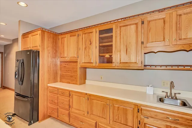a bathroom with a granite countertop sink and a large mirror