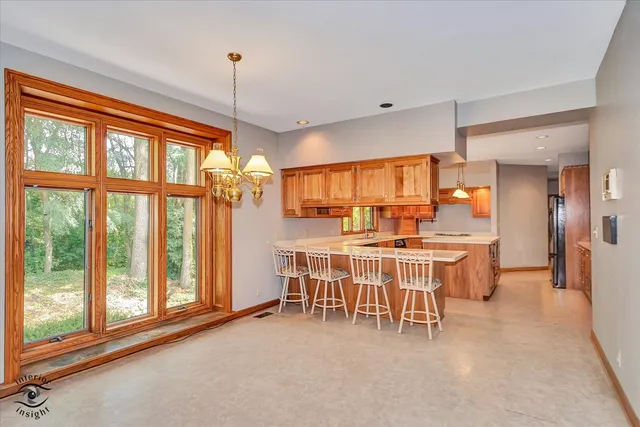 a dining room with a large window table and chairs