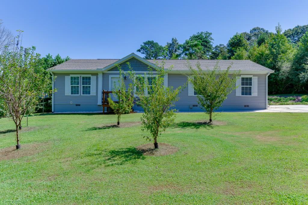 a front view of house with yard and green space