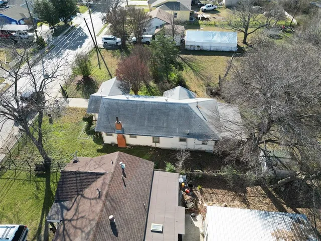 an aerial view of a house with a yard