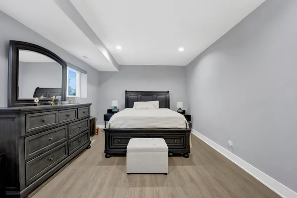 a room with a bed and a dresser