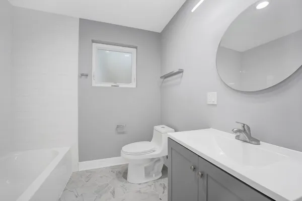 a bathroom with a sink a toilet and a bathtub