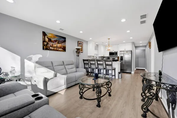 a living room with furniture and kitchen view