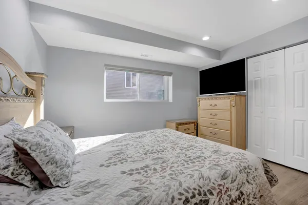 a bedroom with a bed and a flat screen tv