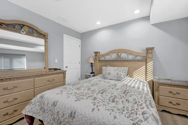 a bedroom with a bed and a dresser