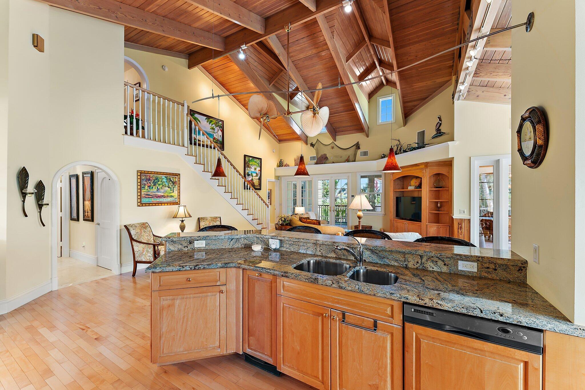 134 North Beach Road Hobe Sound, FL 33455 - Photo 13 of 54 a kitchen with stainless steel appliances granite countertop a sink and cabinets
