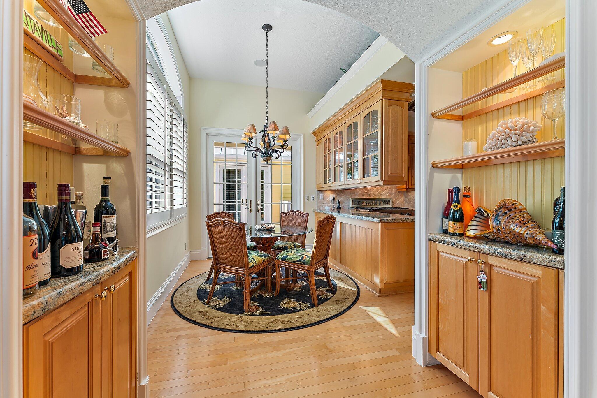 134 North Beach Road Hobe Sound, FL 33455 - Photo 16 of 54 a kitchen with stainless steel appliances granite countertop a sink and a refrigerator