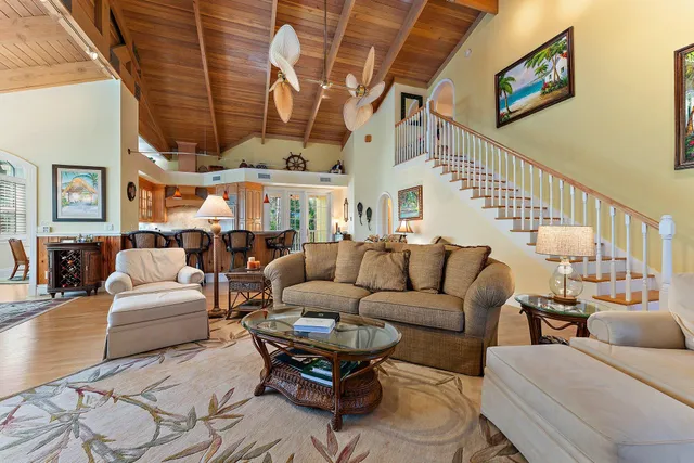 a living room with furniture a ceiling fan and a rug